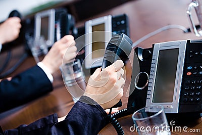 Hands holding phones Stock Photo