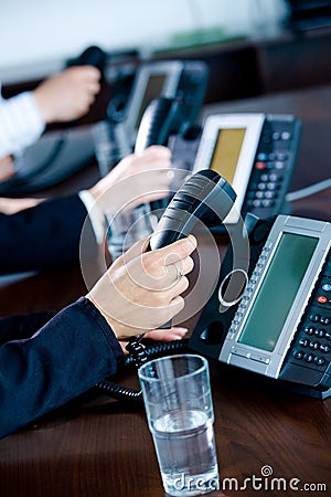 Hands holding phones Stock Photo