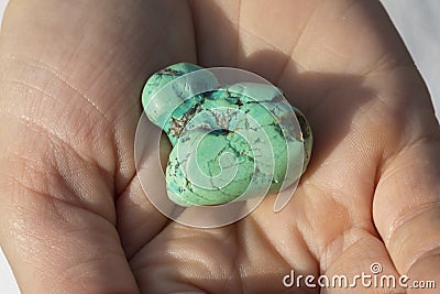 Hands holding piece of turquoise Stock Photo