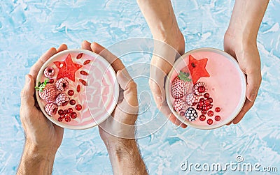 Hands Holding Pink Berry Yogurt Smoothie Bowls Stock Photo