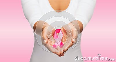 Hands holding pink breast cancer awareness ribbon Stock Photo