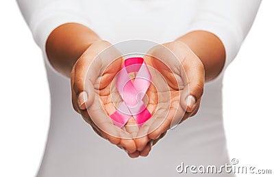 Hands holding pink breast cancer awareness ribbon Stock Photo