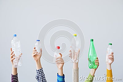 Hands holding plastic bottle on grey background Stock Photo