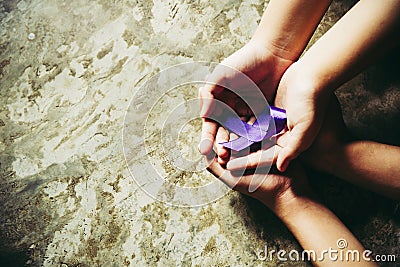 Hands holding Purple ribbons, toning copy space background, Alzheimer disease, Pancreatic cancer, Epilepsy awareness, Stock Photo