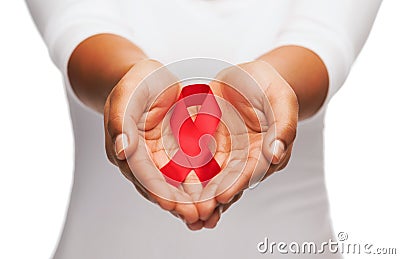 Hands holding red AIDS awareness ribbon Stock Photo