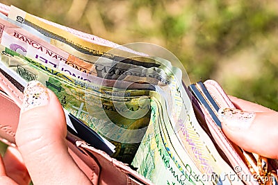 Hands holding and showing wallet with romanian money LEI Stock Photo