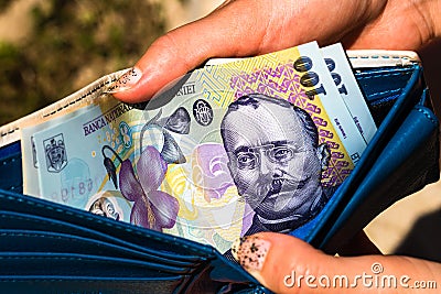 Hands holding and showing wallet with romanian money LEI Stock Photo