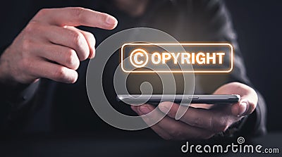 Hands holding smartphone. Copyright. Intellectual Property Stock Photo