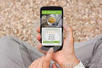 Hands holding smartphone with food application mock up on screen Stock Photo