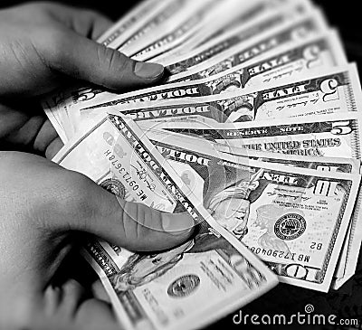 Hands Holding Various Amounts of American Money Stock Photo