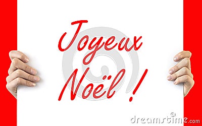 Hands holding a white board Joyeux Noel Stock Photo