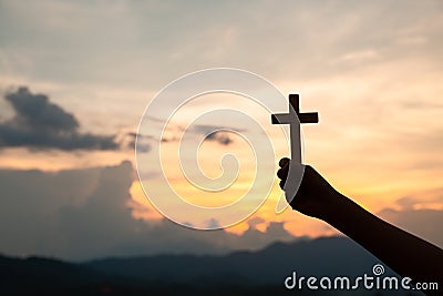 Hands holding wooden cross on sky background, Crucifix, Symbol of Faith Stock Photo