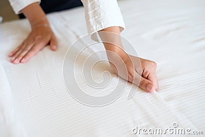 Hands of hotel maid making bed Stock Photo
