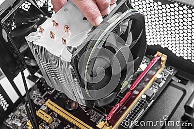 Hands installing a fan on the motherboard Stock Photo