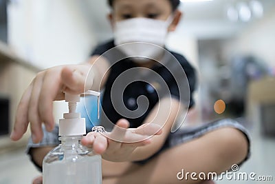 Hands of kid boy with alcohol antiseptic gel,wash hands with hand sanitizer to avoid contamination with Coronavirus,asian child Stock Photo