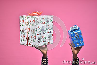 hands lifting up some gift boxes, black people hands only Stock Photo