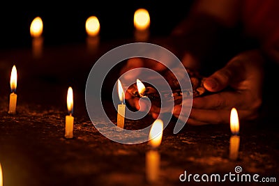Hands Light Up Candles At Night Stock Photo