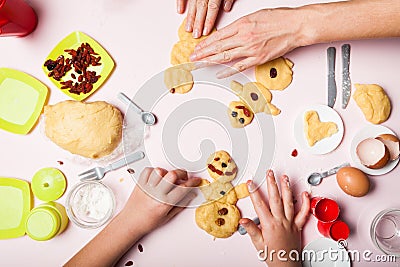 The hands of a little girlish girl and mother make a pastry cookie. Christmas baking. Christmas gingerbread in the shape of Stock Photo