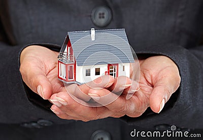 Hands with little house. Stock Photo