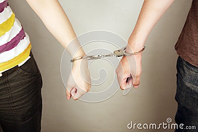 Hands locked with handcuffs Stock Photo