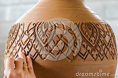 Hands of making clay pot on the pottery wheel ,select focus, close-up. Stock Photo