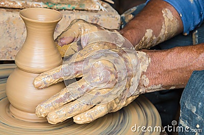 Hands of making clay pot on the pottery wheel ,select focus, close-up. Stock Photo