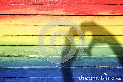 Hands Making Love Heart Shadow on Rainbow Background Stock Photo