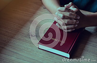Hands of man with Bible praying.Christian life prayer to god. Man Pray for god. Stock Photo