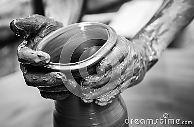 Hands of a man creating pottery on wheel Stock Photo