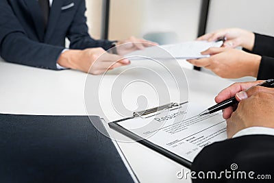 Hands of man giving application portfolio to HR man in office for interview. Stock Photo