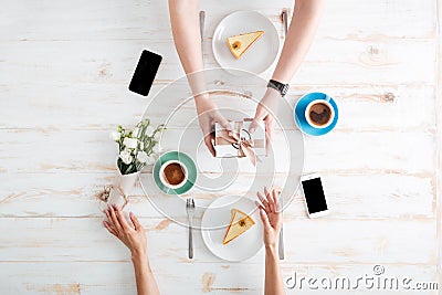 Hands of man giving present to woman on wooden table Stock Photo