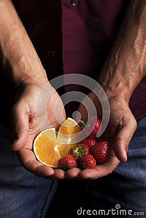 Hands of a man holding fruit Stock Photo