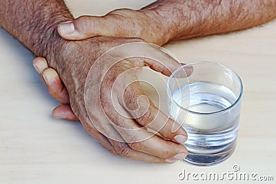 The hands of a man with Parkinson`s disease tremble Stock Photo
