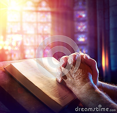 Hands Of A Man Praying Stock Photo