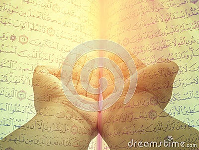 Hands of man praying on quran Stock Photo