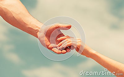 Hands of man and woman on blue sky background. Lending a helping hand. Solidarity, compassion, and charity, rescue Stock Photo