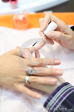 Hands manicure woman by nail polish in salon Stock Photo