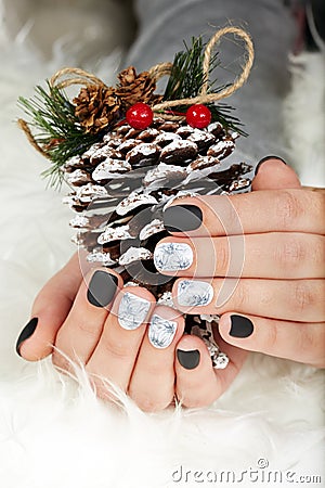 Hands with manicured nails colored with black and white nail polish Stock Photo