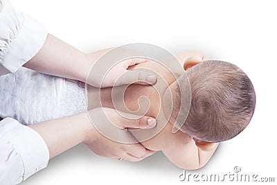 Hands massage the spine of baby Stock Photo