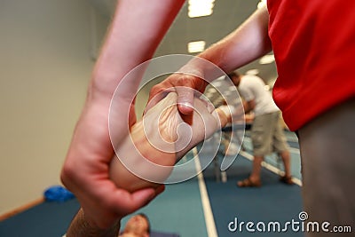 Hands massaging exhausted athlete's foot after running Stock Photo