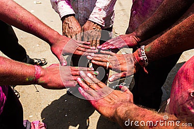 Hands of men painted with colorful powder at Hindu celebration party Stock Photo