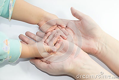 Hands of mother and child Stock Photo