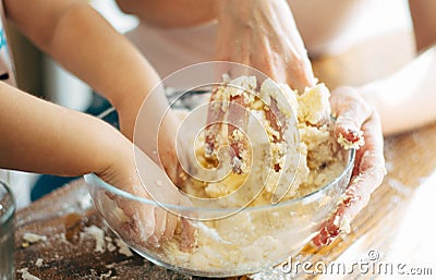 Hands of mother and child making dough Stock Photo