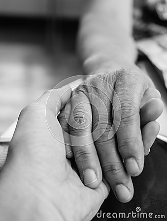 Hands of mother and son holding together in monochrome style Stock Photo