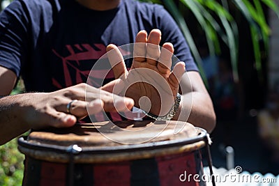 Hands of a musician playing the atabaque. Feeling of power and speed Stock Photo