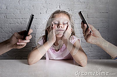 Hands of network addict parents using mobile phone neglecting little sad ignored daughter bored Stock Photo