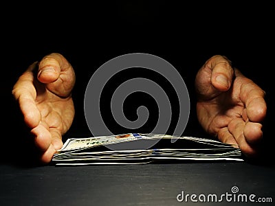 Hands offer money in the dark Free space. Lending and loan. Stock Photo