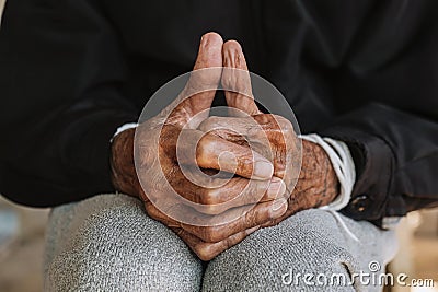 Hands of an old man on the wood table .vintage tone Stock Photo