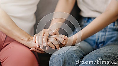 Hands of the old woman and a wman hand in home Stock Photo