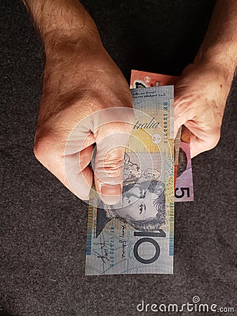 hands of an older man holding australian banknotes Stock Photo